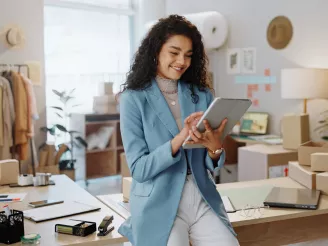 Business woman using a tablet in a small business logistics centre