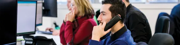 People using phones at their desks