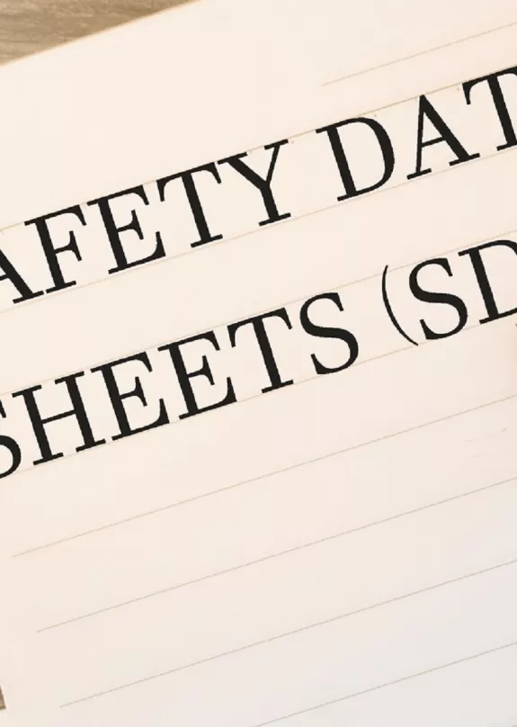 Notepad with 'Safety Data Sheets' written in it next to a cup of coffee