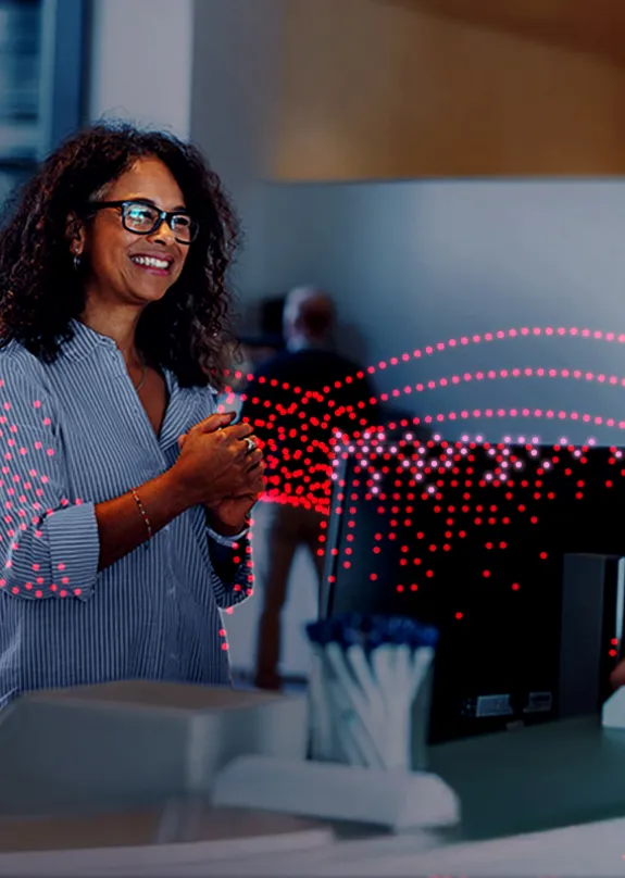 Receptionist greeting people at the front desk